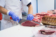 © Garage Island Crew/Stocksy - Butcher cutting slices of beef