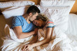 © Garage Island Crew/Stocksy - Happy couple lying in bed
