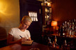 © Emotion Matters/Stocksy - A bartender writing on her notebook.