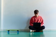 © ALTO IMAGES/Stocksy - Teenage boy sitting on the floor with his laptop
