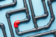 © 365mm/Stocksy - Singular red piece in system of gray pipes