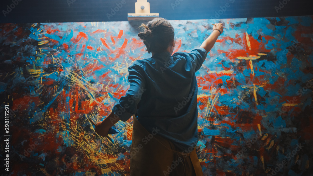 Talented Female Artist Works on Abstract Oil Painting, Using Paint Brush She Creates Modern Masterpiece. Dark and Messy Creative Studio where Large Canvas Stands on Easel Illuminated. - obrazy, fototapety, plakaty 