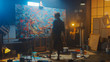 © Gorodenkoff - Talented Female Artist Works on Abstract Oil Painting, with Broad Strokes of Paint Brush She Creates Modern Masterpiece. Dark and Messy Creative Studio where Large Canvas Stands on Easel Illuminated