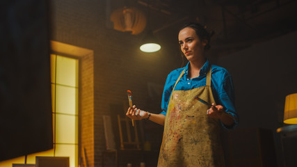 Fototapete - Talented Female Artist Drawing with Paint Brush Energetically, She Creates Modern Masterpiece of the Oil Painting. Creative Studio with Large Canvas of Striking Colors. Low Angle Portrait