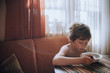 © Irina Polonina/Stocksy - Little boy having breakfast in the kitchen