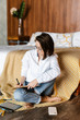 © Alina Hvostikova/Stocksy - Casual girl with notepad in bedroom