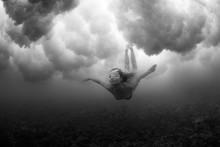Black And White Image Of A Female Freediving. Underwater Dance. Conceptual, Art