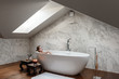 © Milles Studio/Stocksy - Lounging woman in white bath at home