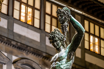 Bronze statue of Perseus holding the head of Medusa in Florence at night, Piazza della Signoria square, made by Benvenuto Cellini in 1545