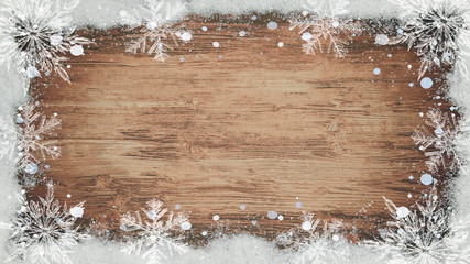 winter / Advent / christmas Background template - Frame made of snow with snowflakes and ice crystals on brown wooden texture, top view with space for text