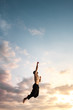 © Alexander Grabchilev/Stocksy - man jumping up to the sky.
