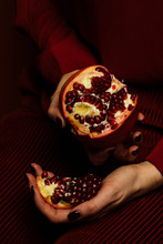 Close Up Of Woman's Hand Holding Pomegranate