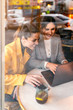 © Santi Nunez/Stocksy - Beautiful women using laptop in coffee shop