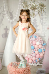 little girl in a white dress posing like a little princess