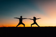 © Javier Pardina/Stocksy - Silhouettes of people training yoga