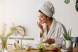 © lordn - Young woman applying face mask at home. Natural Skin Care Routine. Cleaning face with natural cosmetics.