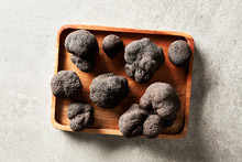 Delicious Black Truffles On Wood Tray