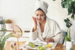 © lordn - Young woman applying face mask at home. Natural Skin Care Routine. Cleaning face with natural cosmetics.