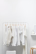 © 365mm/Stocksy - White cloakroom interior with clothing on hangers