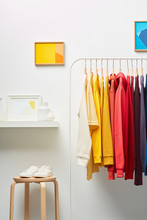 Wardrobe Interior With Multicolored Clothes On Rack