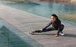 © MEM Studio/Stocksy - Active woman i sports wear stretching