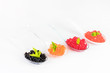 Molecular cuisine caviar elements shot closeup of a plastic buffet table spoon.