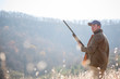 © Jeff Greenough/Tetra Images - Young man holding rifle in field