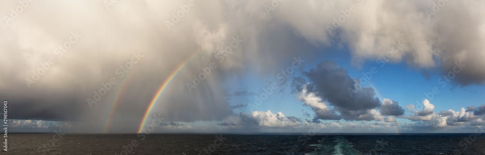 Dramatic Panoramic View of a cloudscape during a rainy and colorful morning with a bright double Rainbow. Taken over the Pacific Ocean in Alaska, USA. - obrazy, fototapety, plakaty 