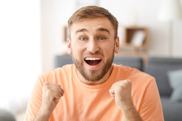 Canvas Print - Excited young man at home