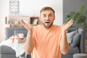 Canvas Print - Surprised young man at home