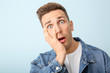 © Pixel-Shot - Shocked young man on color background