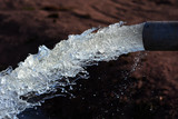 Fototapeta Tęcza - water flow out from pipe by pump supply for dry season	