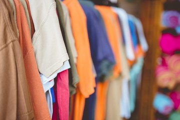 Wall Mural - Closeup shot of different color t-shirts with  blurred background