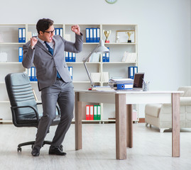 Businessman having fun taking a break in the office at work