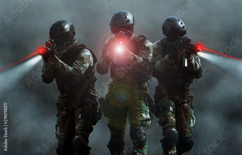 Fotografía Special force assult team at night with laser sights and smoke screen background