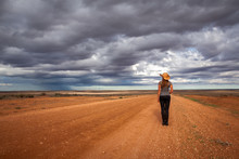 Farm Girl Watching Storm Over The Arid Desert
