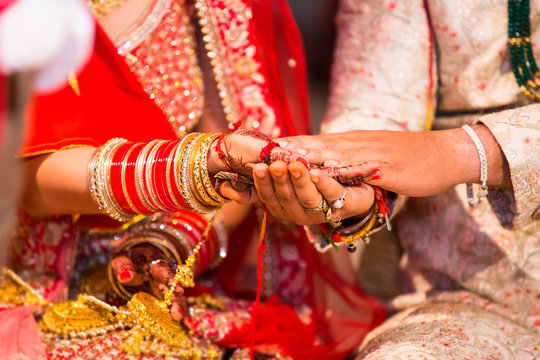 Closeup of indian couple holding hands as promise care and trust for lifetime marriage, wedding, togetherness. life partner 