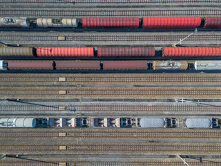 Wall Mural - Aerial view of freight train wagons on large railway track field. Concept of modern logistics.