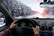 A man drives a car on a winter road