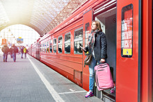 Woman Tourist With Suitcase Coming Out Of Train
