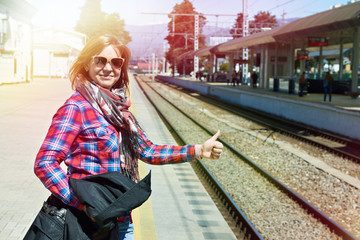 Poster - Woman thumbs up on railroad station