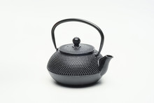 Black Cast Iron Teapot On A White Background.