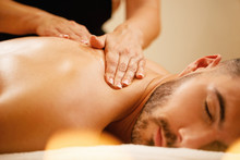 Close-up Of Man Having Back Massage With Honey At Health Spa.