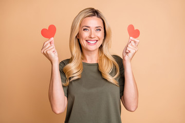 Sticker - Photo of cheerful cute nice pretty positive glad pleased girlfriend smiling toothily wearing green t-shirt holding two small hearts she received from her beloved one isolated pastel color background