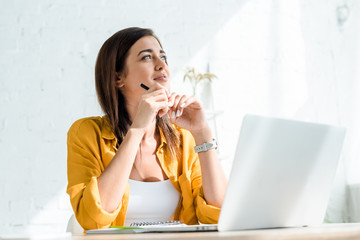 beautiful thoughtful freelancer working on laptop in home office