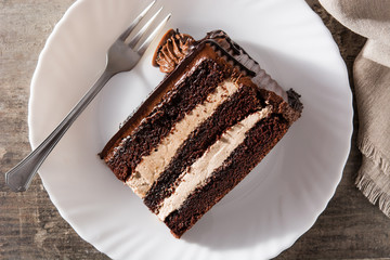 Chocolate cake slice on wooden table. Top view