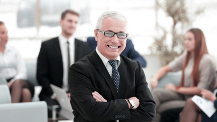 Wall Mural - portrait of senior businessman on background of office