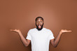 © deagreez - Portrait of his he nice attractive shocked amazed bearded guy wearing white tshirt holding invisible objects on palms isolated over dark brown platinum pastel color background