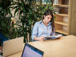 © Nejron Photo - Young woman reading book in public library