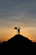© cofficevit - Silhouette of people and flag on top mountain, sky and sun light background. Business success and goal concept.